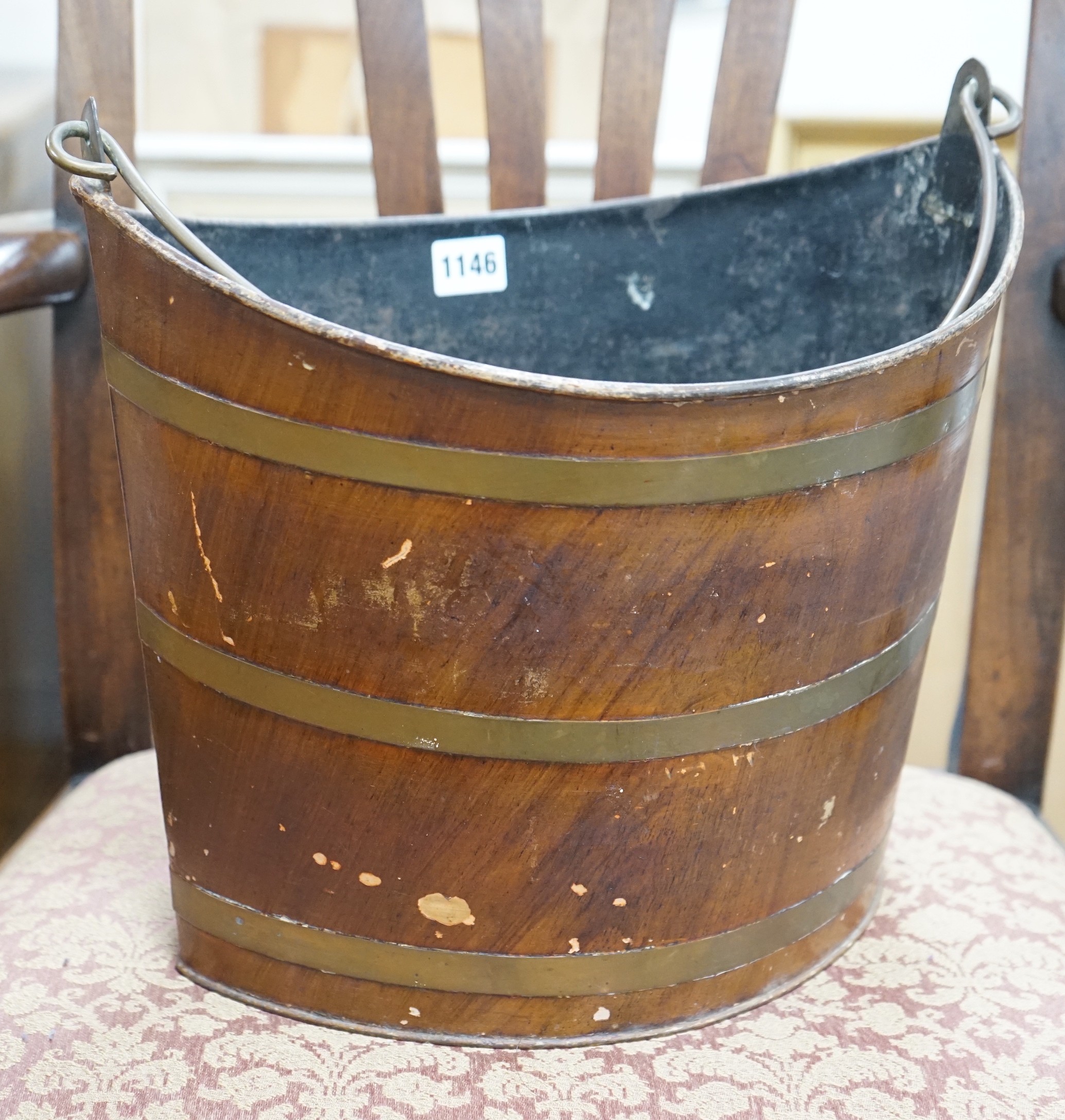 A Regency Toleware bucket with simulated mahogany and brass effect